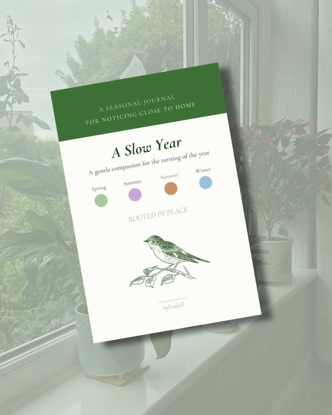 A Slow Year Rooted in Place journal cover resting on a sunlit windowsill